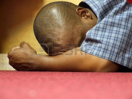 832225-intensity--of-worship-and-prayer-a-black-male-in-intense-prayer-stress-or-contemplation-at-an-all-ni
