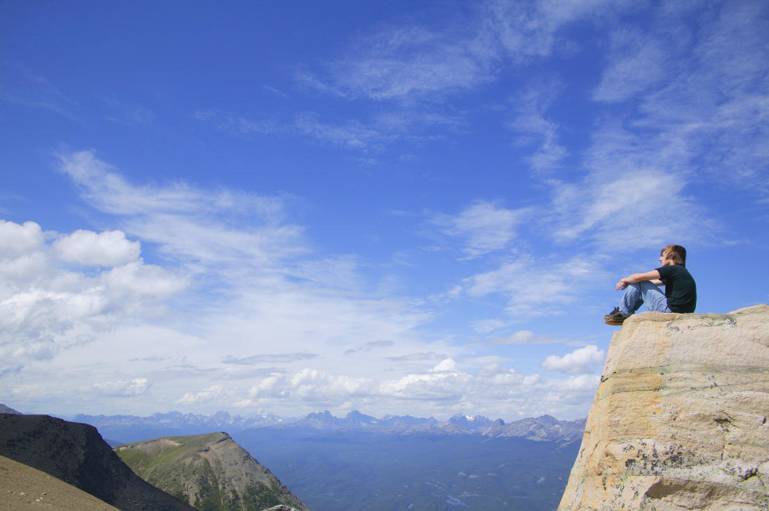 Boy on top of mountain enjoying the view
