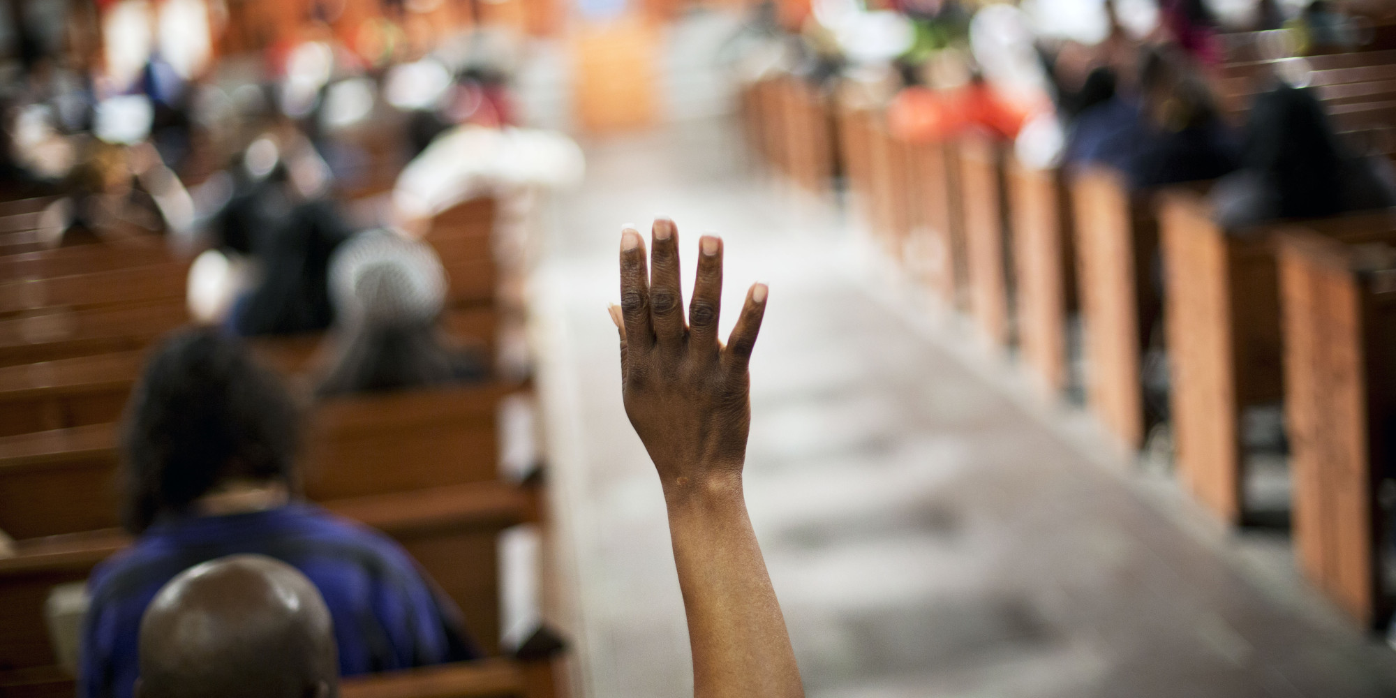 Morma Francis, of Atlanta, raises her hand to ask a question during a community town hall forum at Ebenezer Baptist Church, the church where The Rev. Martin Luther King Jr. preached, Monday, Dec. 8, 2014, in Atlanta. Dozens of people met at the church to discuss recent cases of unarmed black men being fatally shot by police and ways to improve the way officers interact with the public.(AP Photo/David Goldman)