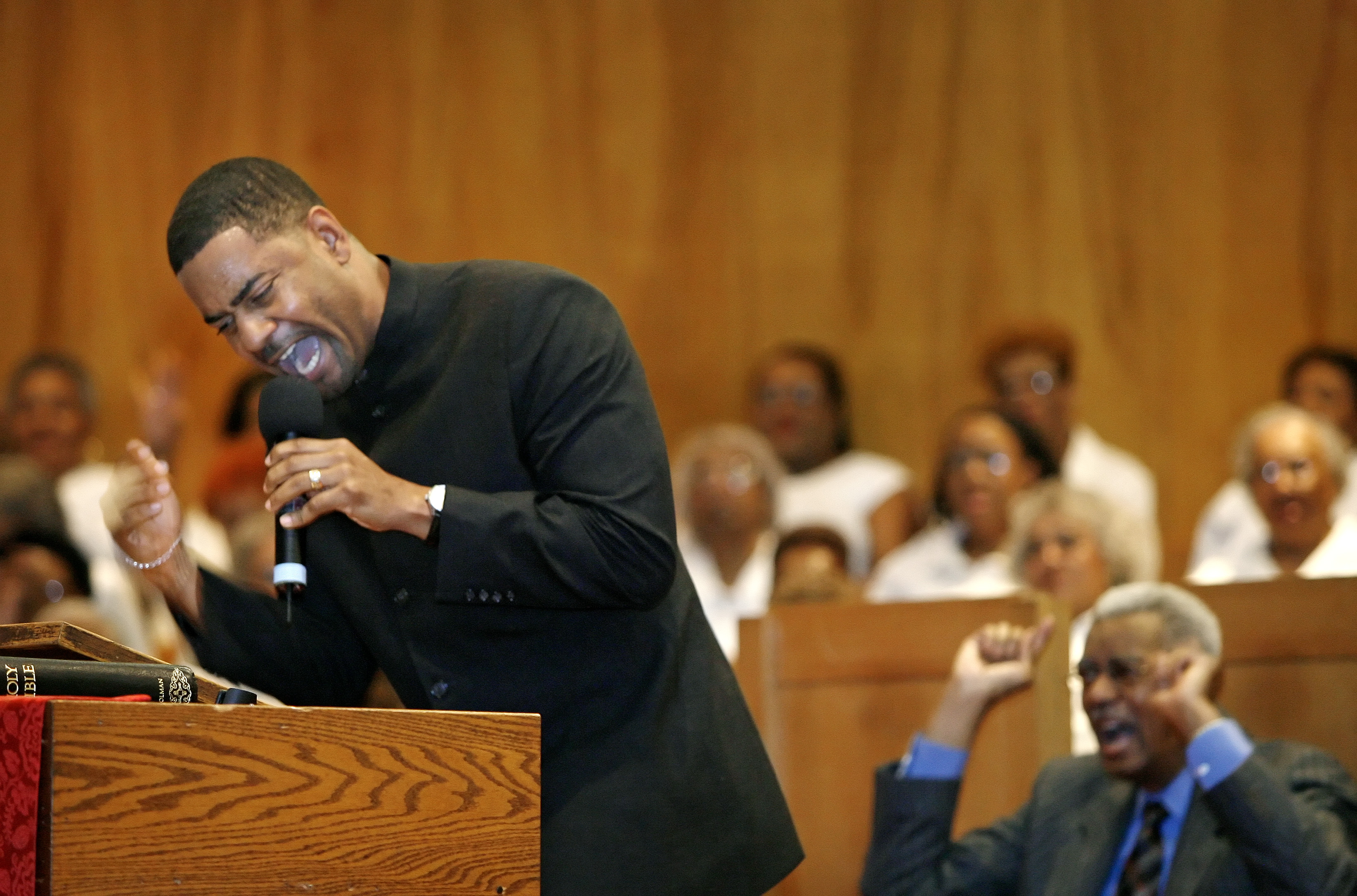 For Diana Keough Story -- Left, Rev. Otis Moss, III preaches during the annual revival at Olivet Institutional Baptist Church in Cleveland while his father, Pastor Otis Moss, Jr. sits behind him. March 21, 2007 (Lonnie Timmons III/Plain Dealer)